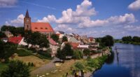 View of Eisenhuttenstadt, Germany, with a church and river.