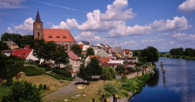 View of Eisenhuttenstadt, Germany, with a church and river.