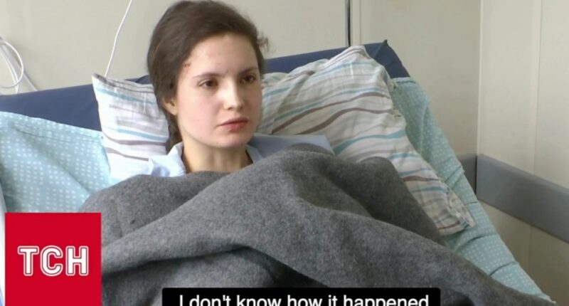 Injured woman in hospital bed.
