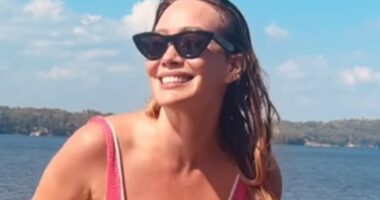Hilary Duff, 37, looks slender in a low-cut pink swimsuit thanks to 'mindful eating'... after welcoming 4th child