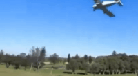 Small plane making an emergency landing on a golf course.