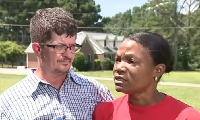 Couple being interviewed about a forged deed.