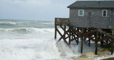Hurricane Erin stirs up strong winds and floods part of a NC highway as it creeps up the East Coast