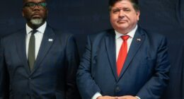 Illinois Gov. JB Pritzker, right, stands with Chicago Mayor Brandon Johnson during a Democratic National Convention security briefing at the U.S. Secret Service's Chicago Field Office Thursday, July 25, 2024, in Chicago. (AP Photo/Erin Hooley)