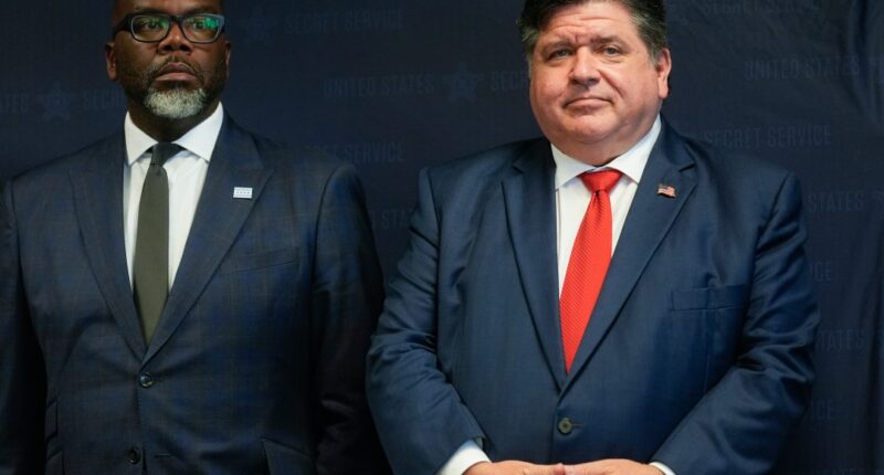 Illinois Gov. JB Pritzker, right, stands with Chicago Mayor Brandon Johnson during a Democratic National Convention security briefing at the U.S. Secret Service's Chicago Field Office Thursday, July 25, 2024, in Chicago. (AP Photo/Erin Hooley)