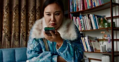 Still from the film *Mistress Dispeller*, directed by Elizabeth Lo.  A woman uses a smartphone.
