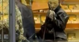 Person in Guy Fawkes mask during Ginza robbery.