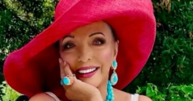 Joan Collins flaunts her incredible figure in a chic white swimsuit