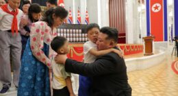 Kim Jong Un embracing children of fallen soldiers at an award ceremony.