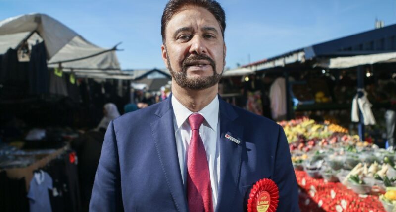 Afzal Khan, Labour's candidate, at a market.