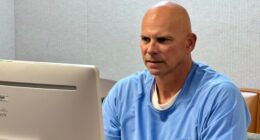 Lyle Menendez in prison clothing before computer monitor