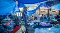 Migrants in a makeshift camp outside Paris City Hall awaiting emergency housing.