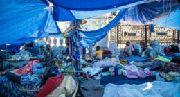 Migrants in a makeshift camp outside Paris City Hall awaiting emergency housing.