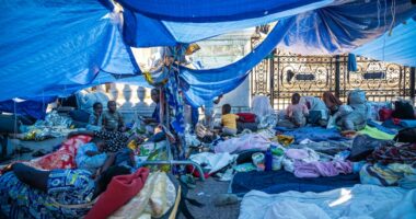 Migrants in a makeshift camp outside Paris City Hall awaiting emergency housing.