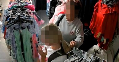 Moment brazen shoplifters stuff £100 of kids' clothes into rucksack