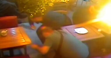 Moment gunman fires bullets into restaurant as rival gang run
