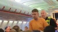 Moment plane passenger is detained by police after row diverted flight