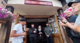 Moment pub-goers wearing flag turned away for refusing to take it off