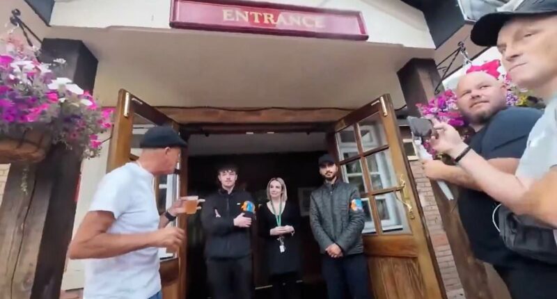 Moment pub-goers wearing flag turned away for refusing to take it off