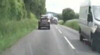 A car speeding down a country road during a police chase.
