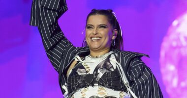 Nelly Furtado storms the stage in a racy cut out top and mini skirt