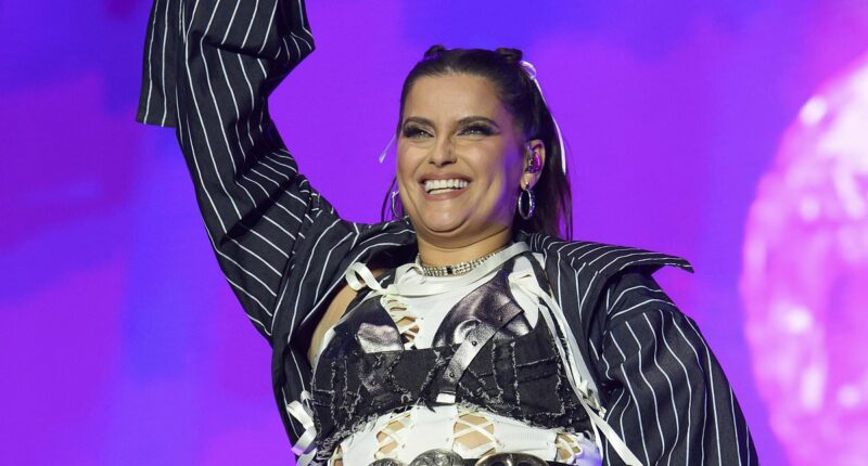 Nelly Furtado storms the stage in a racy cut out top and mini skirt