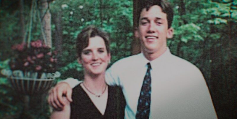 Photo of a young couple posing outdoors.