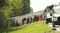 First responders work to rescue victims at the scene of a tour bus that crashed and rolled over on the New York State Thruway near Pembroke, N.Y., Friday, Aug. 22, 2025. (Libby March/Buffalo News via AP)
