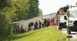 First responders work to rescue victims at the scene of a tour bus that crashed and rolled over on the New York State Thruway near Pembroke, N.Y., Friday, Aug. 22, 2025. (Libby March/Buffalo News via AP)