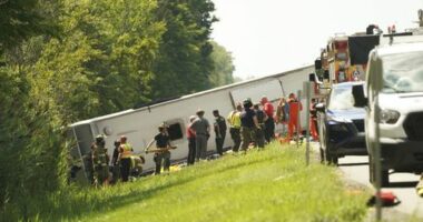 First responders work to rescue victims at the scene of a tour bus that crashed and rolled over on the New York State Thruway near Pembroke, N.Y., Friday, Aug. 22, 2025. (Libby March/Buffalo News via AP)