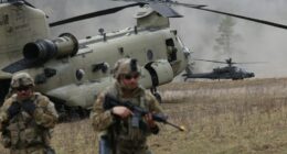 Soldiers and helicopters during a NATO military exercise.