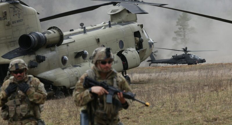 Soldiers and helicopters during a NATO military exercise.