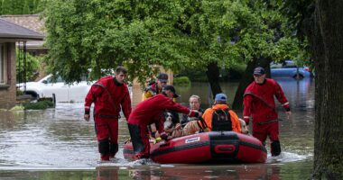Over 900 flights delayed and 14 million remain under flood alerts