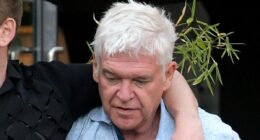 Phillip Schofield is worse-for-wear while supported by handsome male