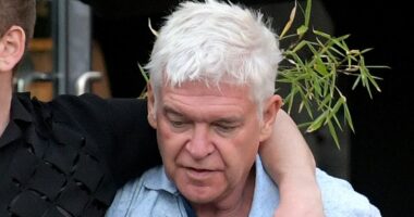 Phillip Schofield is worse-for-wear while supported by handsome male
