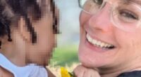 Photo of a smiling woman holding a toddler.