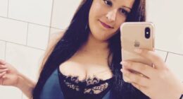 Selfie of a woman in a blue dress.