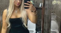 Selfie of a blonde woman in a black dress.