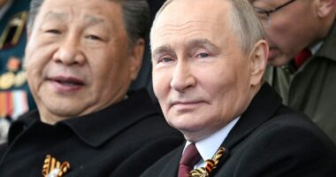 Vladimir Putin and Xi Jinping at a military parade.