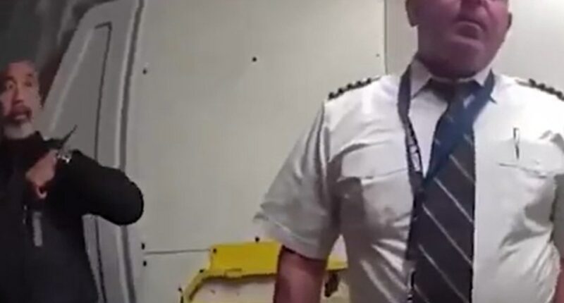 Police officer escorting a pilot from a cockpit.