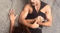 Man holding another man in a wrestling hold.