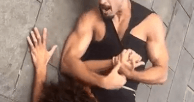 Man holding another man in a wrestling hold.