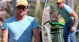 Simon Baker works up a sweat as he mows the lawn outside his home