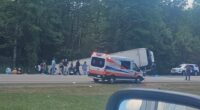 Aftermath of a bus crash on I-90 near Pembroke, NY, showing emergency personnel and victims.