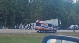 Aftermath of a bus crash on I-90 near Pembroke, NY, showing emergency personnel and victims.