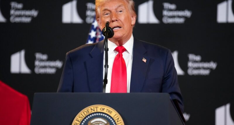 Donald Trump speaking at a podium.