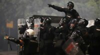 Tensions soar in Serbia as angry protesters clash with police, set fire to party offices