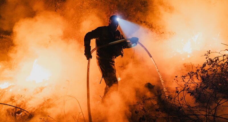 Tourists run during 'Satan's Storm' in Spain as country battles fires