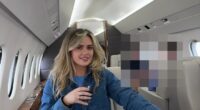 Woman sitting in a private jet, holding a drink.