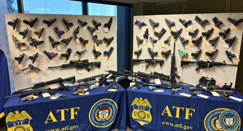 Weapons seized by ATF are displayed during press conference